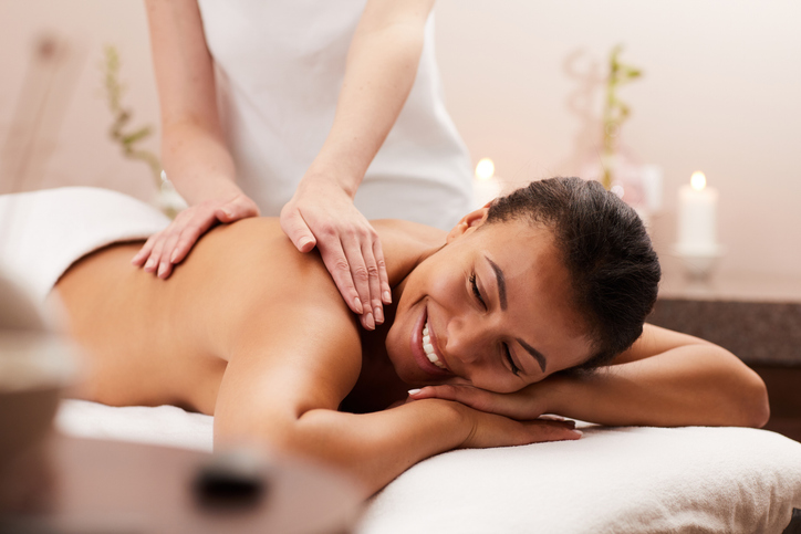 Smiling Woman Enjoying Massage in Spa